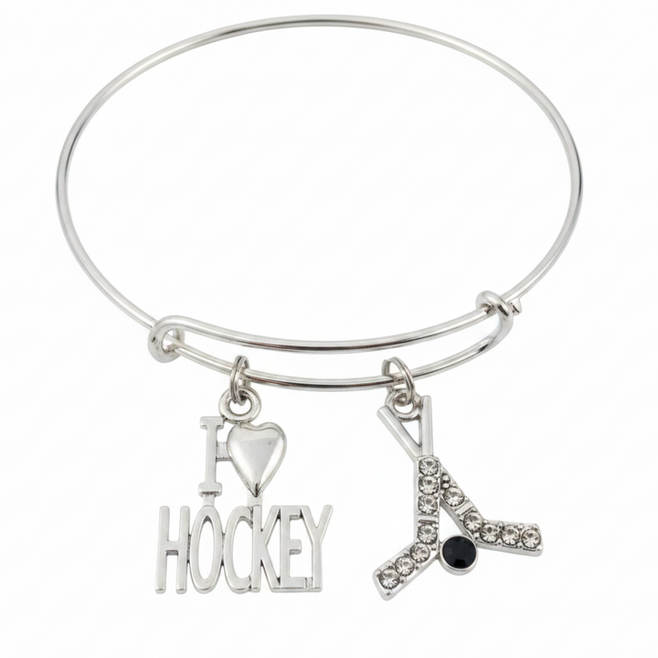 Silver expandable bangle bracelet with I Love Hockey word charm and crystal rhinestone crossed hockey sticks with black puck charm on white background – Jules Obsession hockey fan gift jewelry