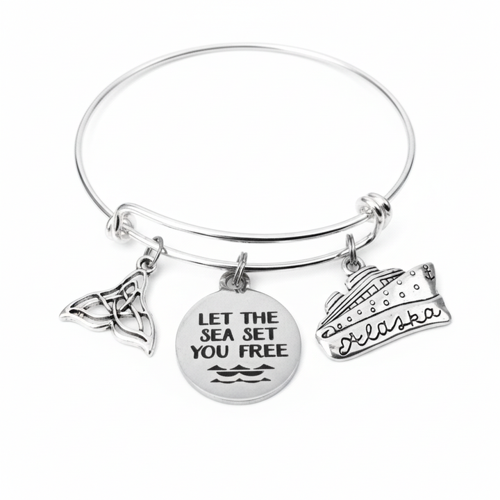 Alaska cruise charm bracelet with whale tail, Let the Sea Set You Free disc and Alaska cruise ship charms on silver expandable bangle by Jules Obsession