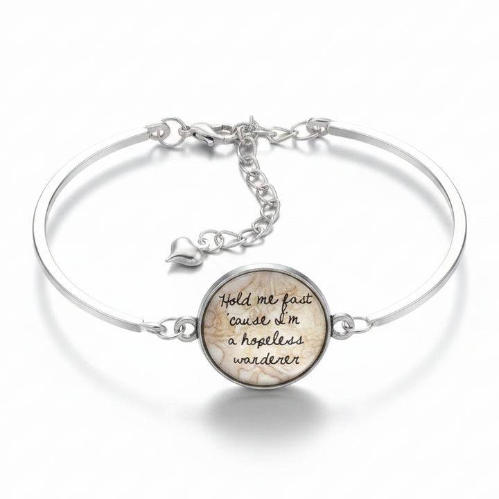 Hopeless Wanderer quote glass dome silver cuff bracelet with puffy heart charm on white background – wanderlust jewelry by Jules Obsession