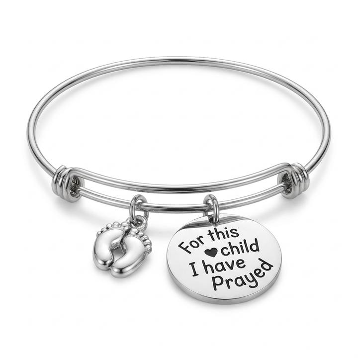 Stainless steel expandable bangle with silver-plated baby feet and round For This Child I Have Prayed charms on a white background.