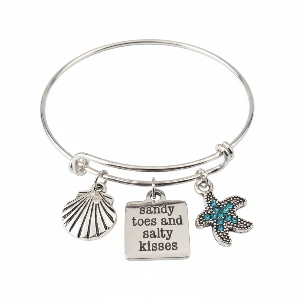 Sandy Toes and Salty Kisses silver expandable charm bangle bracelet featuring engraved square disc, seashell charm, and teal crystal starfish charm attached with jump rings — Jules Obsession beach jewelry, made in USA