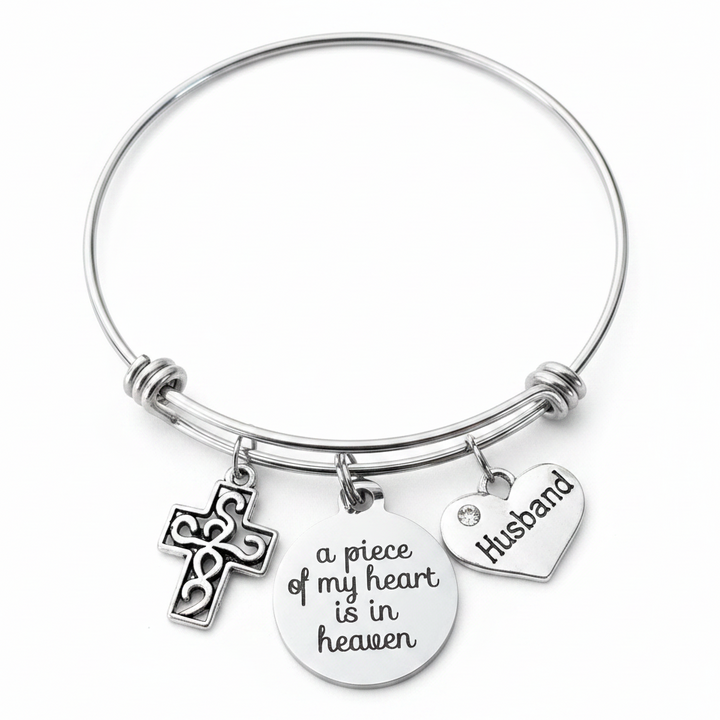 Silver husband memorial charm bracelet with filigree cross, a piece of my heart is in heaven disc charm, and Husband heart charm on expandable wire bangle