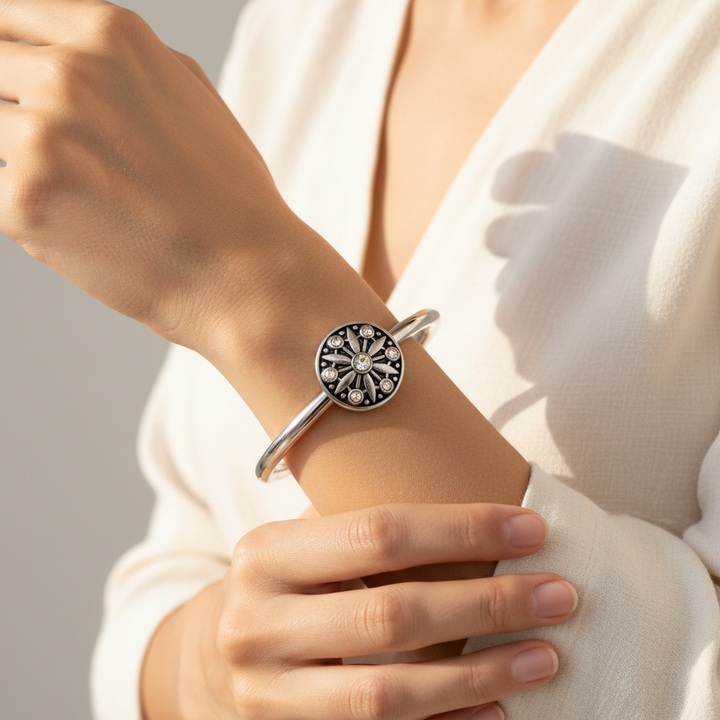 Woman wearing dark silver sunburst aurora crystal snap hinged cuff bracelet – boho statement jewelry by Jules Obsession