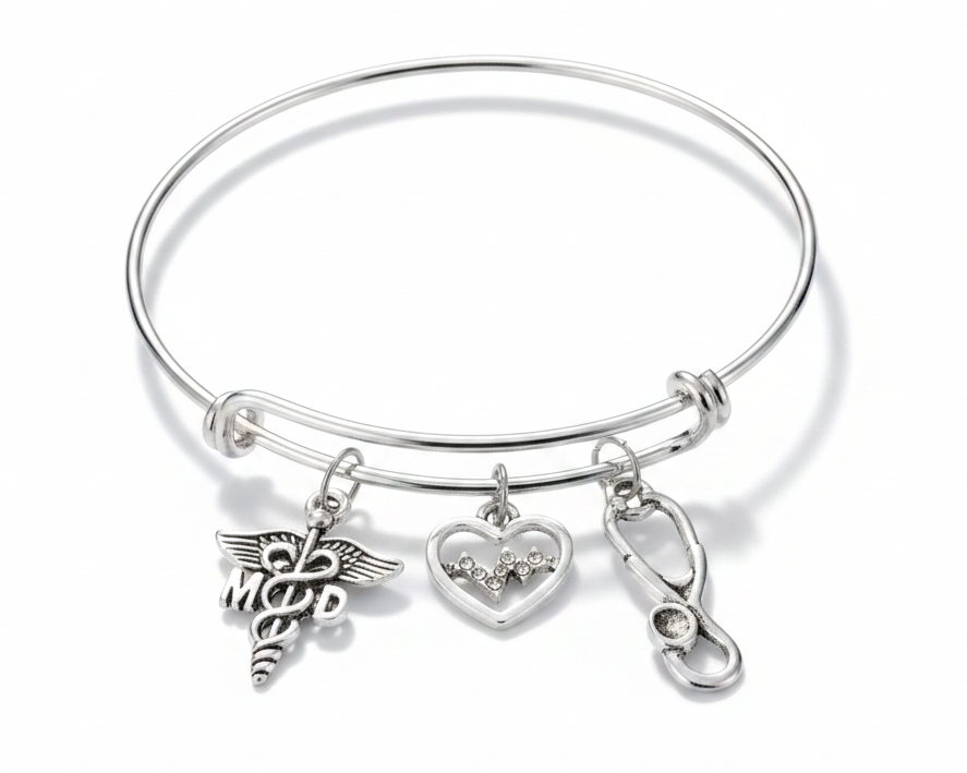 Silver expandable bangle bracelet with MD caduceus charm, crystal EKG heart charm, and stethoscope charm on white background — physician gift jewelry