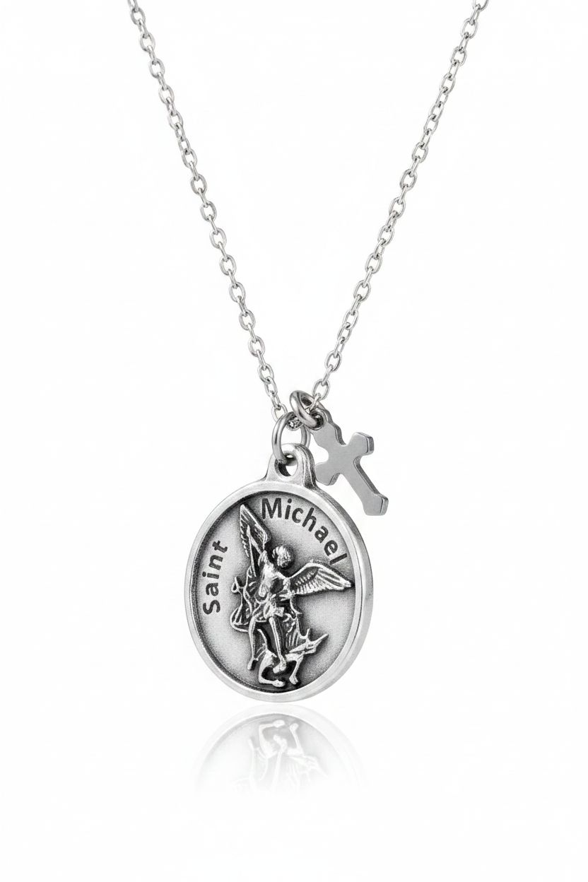 Silver Saint Michael the Archangel round medal necklace with small cross charm on delicate cable chain, on white studio background