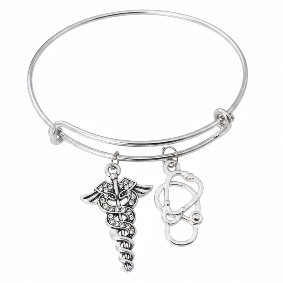 Silver expandable bangle bracelet with crystal caduceus medical symbol charm and stethoscope charm, studio photo on white background