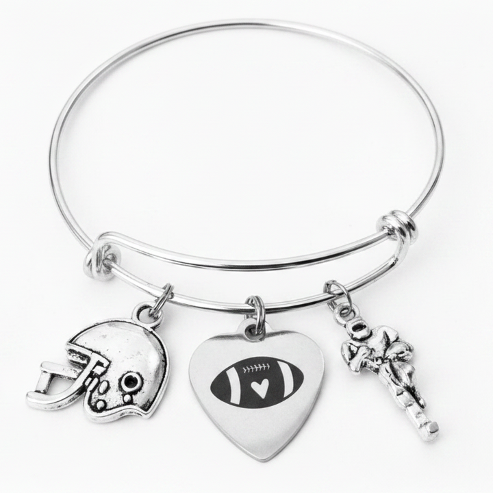 Silver expandable bangle bracelet with three football-themed charms: football helmet, heart-shaped football charm, and Football Player charm on white background
