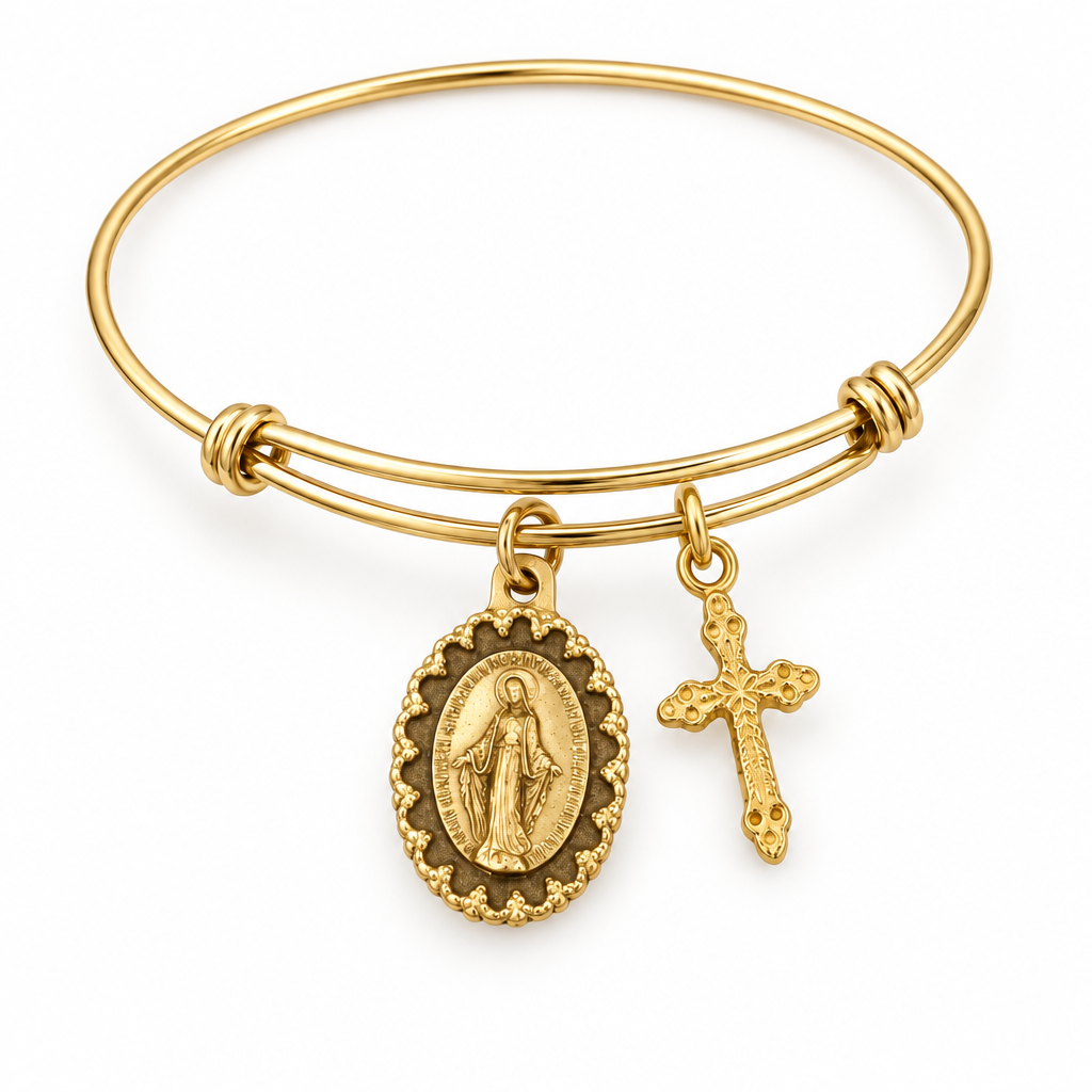 Gold-tone bangle bracelet with an oval religious medal charm and a matching gold cross charm on a white background.