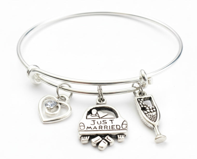Just Married Bracelet – Wedding Gift Charm Bangle for the Bride Silver bracelet with 'Just Married' charm and other wedding-themed charms on a white background