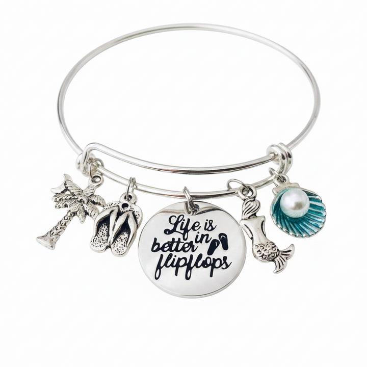 Silver expandable bangle bracelet with beach charms including palm tree, flip flops, engraved Life is Better in Flip Flops disc, mermaid, and teal seashell with pearl — Jules Obsession beach jewelry gift for her