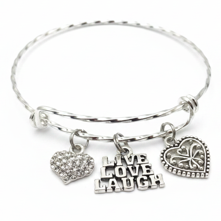 Silver twisted wire expandable bangle bracelet with three charms: crystal pave heart, Live Love Laugh text charm, and ornate filigree heart — inspirational gift for her