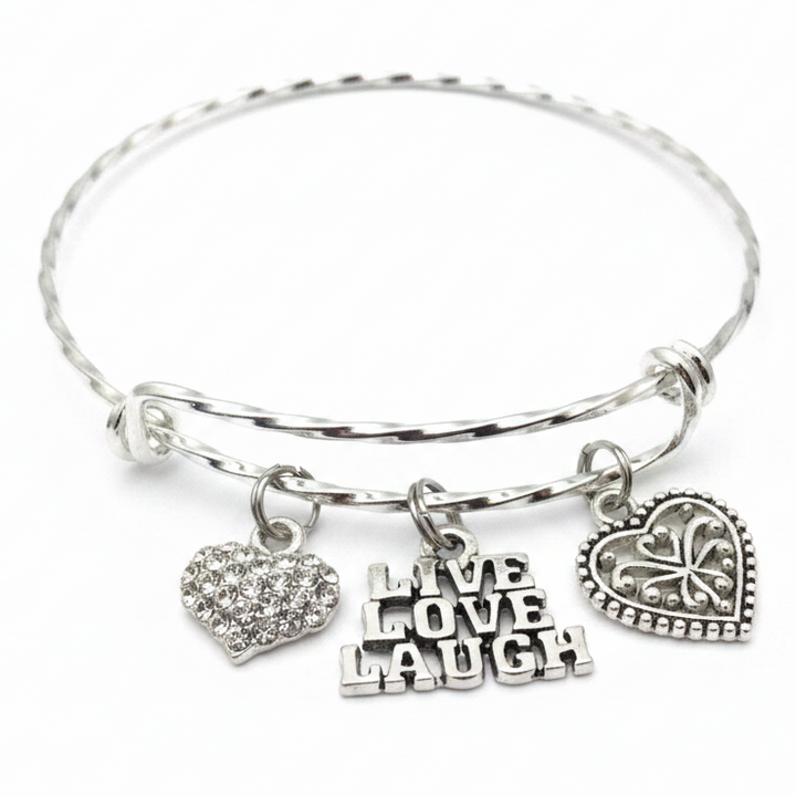 Silver twisted wire expandable bangle bracelet with three charms: crystal pave heart, Live Love Laugh text charm, and ornate filigree heart — inspirational gift for her