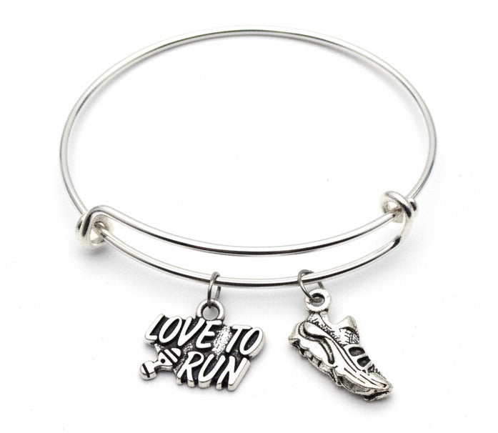 Silver expandable bangle bracelet with Love to Run text charm and running shoe charm on white background – Jules Obsession handmade runner jewelry gift