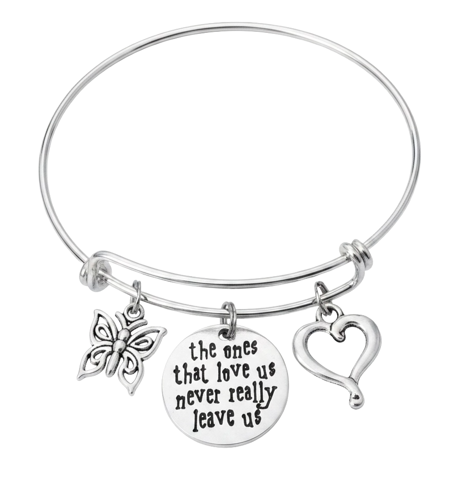 A silver-toned expandable wire bangle bracelet with three charms: a butterfly, a round engraved disc reading 'the ones that love us never really leave us,' and an open heart.