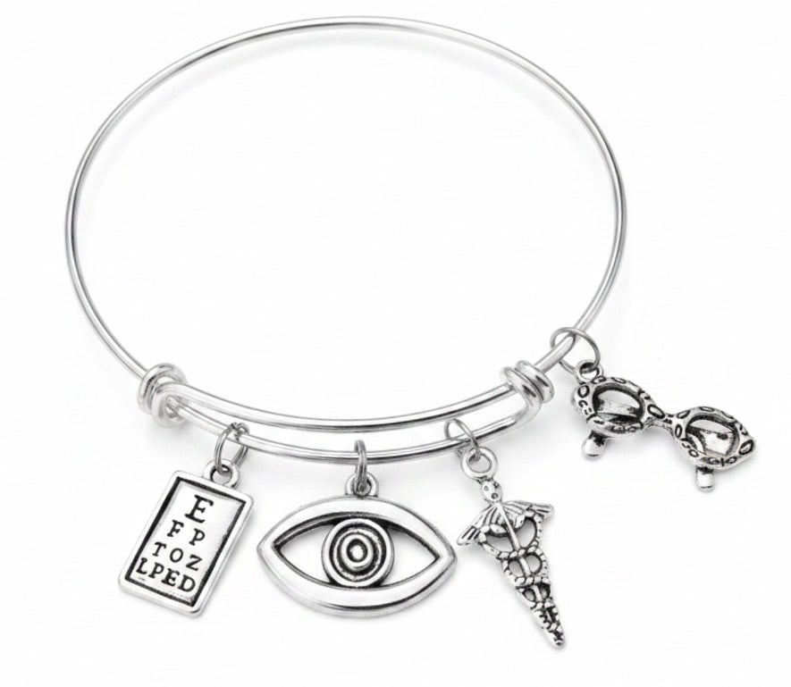 Silver expandable bangle bracelet with eye chart charm, eye charm, caduceus medical symbol charm, and eyeglasses charm — optometrist and eye doctor gift bracelet by Jules Obsession