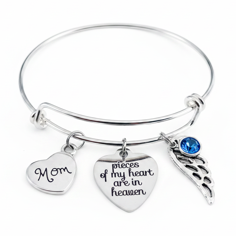 Silver memorial bangle bracelet with Mom heart charm, "pieces of my heart are in heaven" engraved heart, angel wing, and birthstone crystal