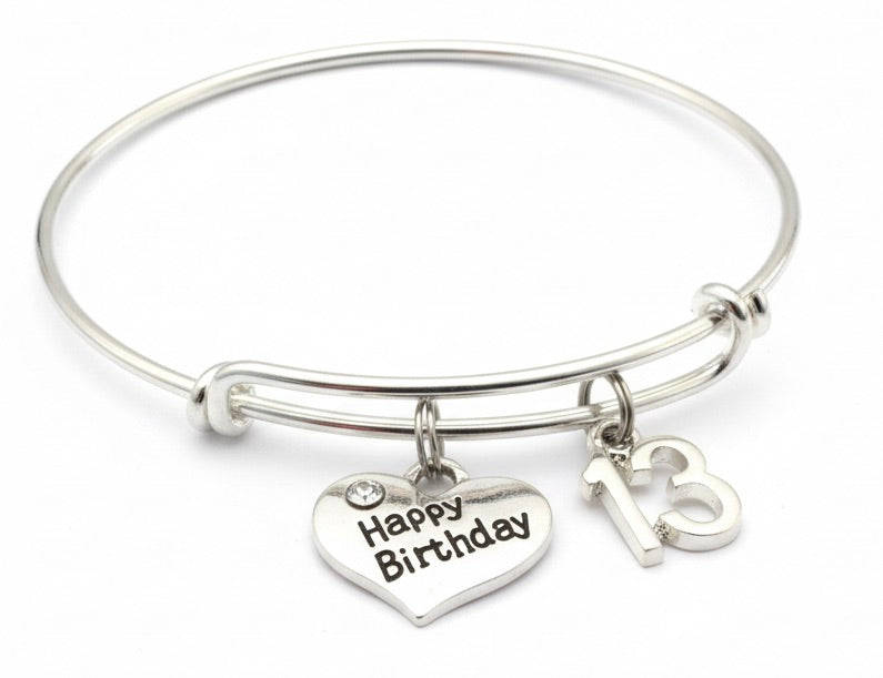 Silver bracelet with 'Happy Birthday' heart charm and number 13 tag on a white background