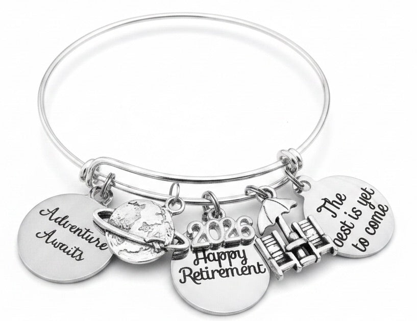 Silver expandable charm bangle bracelet with Adventure Awaits, 2026, Happy Retirement and The Best Is Yet to Come engraved disc charms on white background – Jules Obsession retirement gift for women
