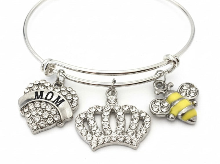 Silver expandable charm bangle bracelet with crystal pavé MOM heart charm, rhinestone crown charm, and yellow enamel bumblebee charm with crystal wings — Queen Bee Mom gift bracelet by Jules Obsession