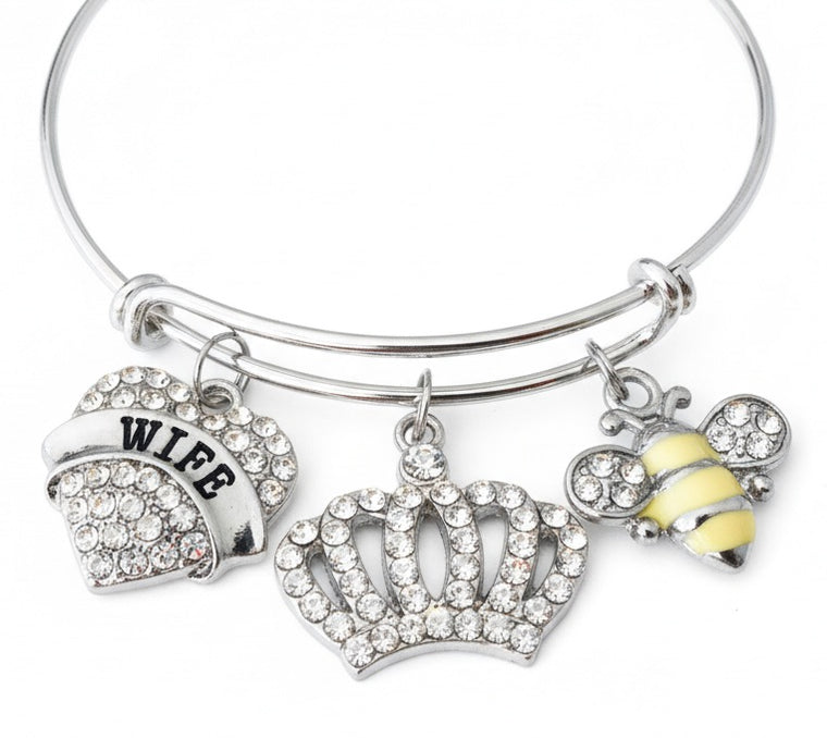 Silver expandable charm bangle bracelet with crystal pavé WIFE heart charm, rhinestone crown charm, and yellow enamel bumblebee charm with crystal wings — Queen Bee Wife gift bracelet by Jules Obsession