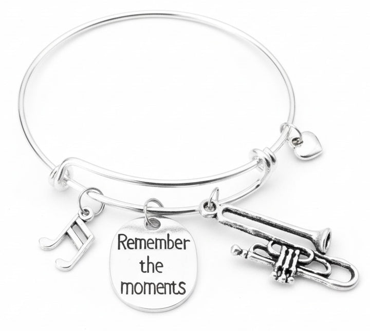 Silver expandable bangle bracelet with trumpet, musical notes, engraved Remember the Moments disc, and heart charms — music gift bracelet by Jules Obsession"