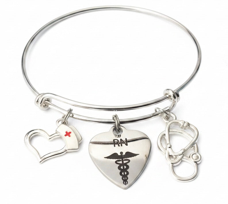 Silver expandable bangle bracelet for registered nurses featuring RN caduceus heart charm, stethoscope charm, and nurse hat charm with red cross