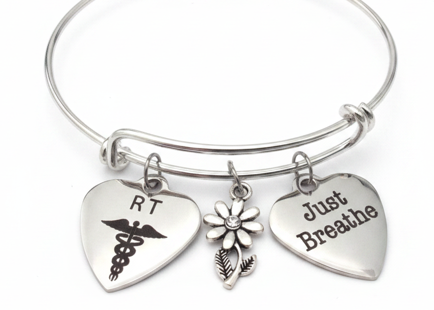 A silver wire expandable bracelet with three heart-shaped charms: one engraved with &