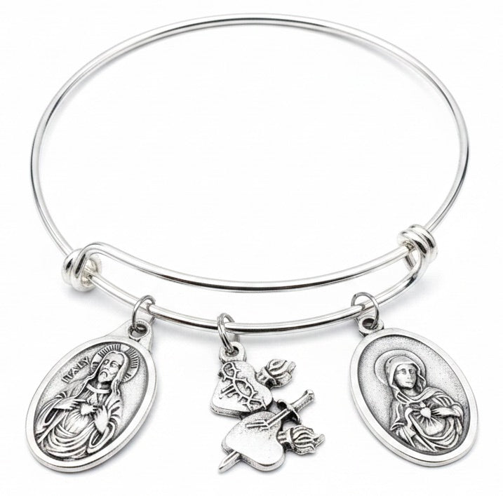 Silver expandable bangle bracelet with three Catholic charms: Sacred Heart of Jesus oval medal, Immaculate Heart of Mary oval medal, and Sacred Heart charm with roses and sword, handmade Catholic religious jewelry gift for women"