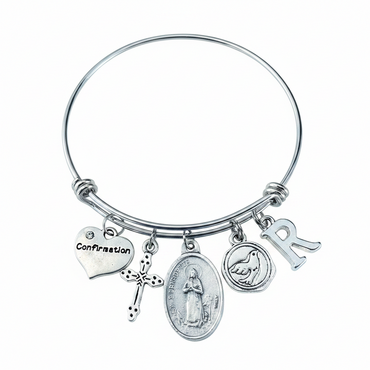 Confirmation charm bangle bracelet with St. Bernadette oval saint medal, cross charm, dove medallion, Confirmation heart, and letter initial charm