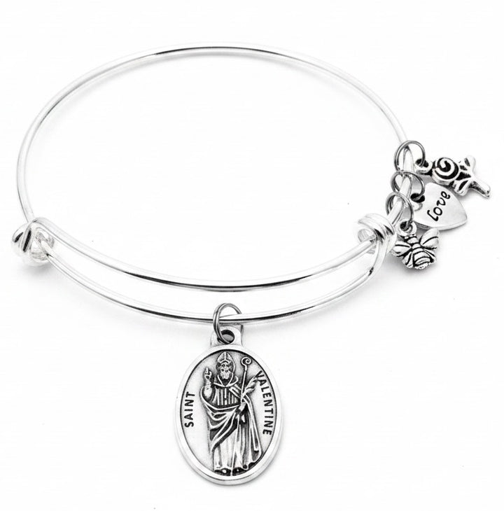Saint Valentine charm bangle bracelet featuring Italian oval Saint Valentine medal, bee charm, love heart charm, and rose charm
