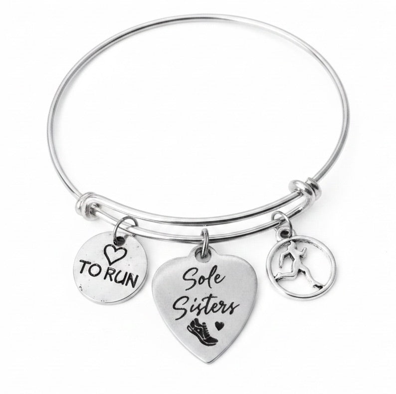 Silver expandable bangle bracelet with Sole Sisters heart charm, Love to Run round charm, and female runner silhouette charm on white background – Jules Obsession handmade running best friend jewelry gift"