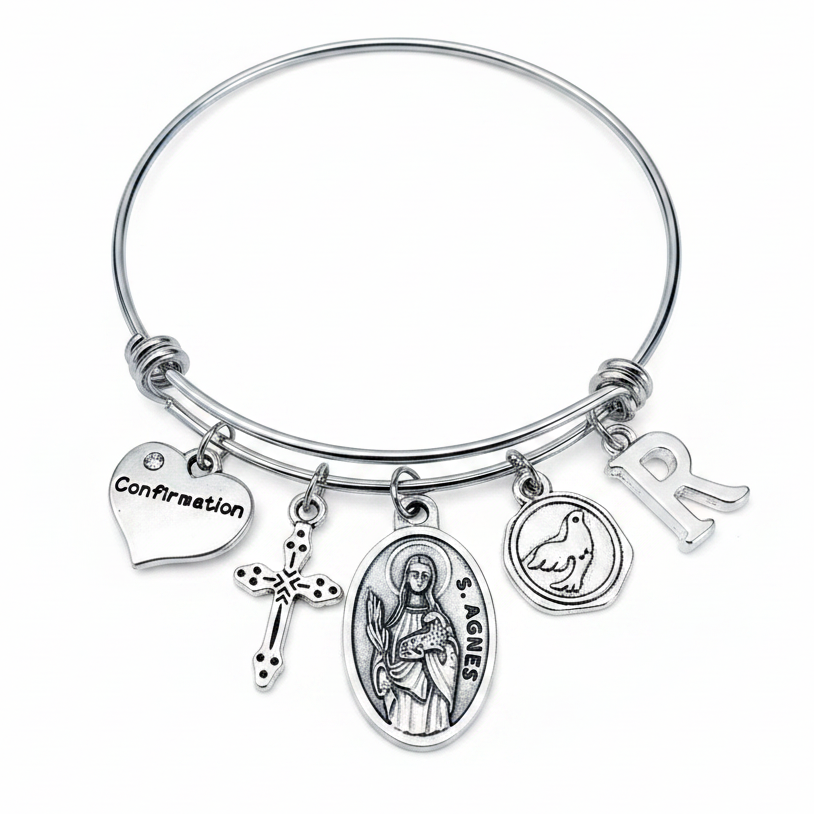 Confirmation charm bangle bracelet featuring Saint Agnes saint medal, decorative cross charm, Confirmation heart, Holy Spirit dove medallion, and personalized silver initial charm