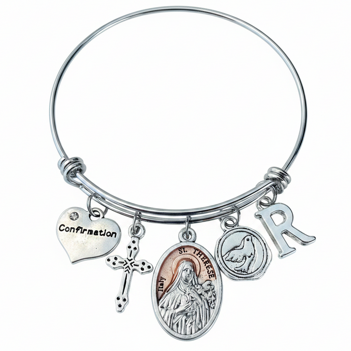 St. Therese of the Little Flower silver-plated saint medal on an adjustable stainless steel bangle with a Holy Spirit dove and personalized initial.