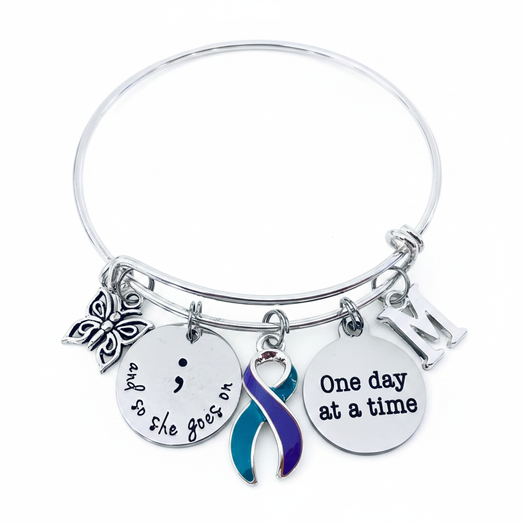 Suicide Prevention Awareness Bracelet with semicolon, teal and purple ribbon, butterfly, and "One day at a time" charm on adjustable silver bangle — gift-ready jewelry for mental health advocates and survivors