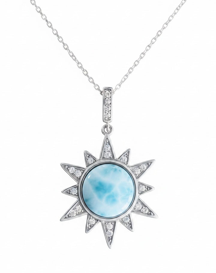 Sunshine Larimar necklace in sterling silver with round blue Larimar stone, sparkling sun ray pendant and pavé bail on white background