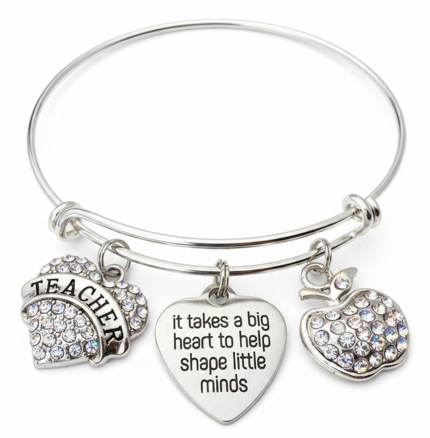 Silver expandable bangle bracelet with rhinestone Teacher arch charm, engraved heart charm reading "It Takes a Big Heart to Help Shape Little Minds," and sparkling rhinestone apple charm — teacher appreciation gift bracelet