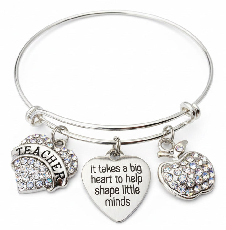 Silver expandable bangle bracelet with rhinestone Teacher arch charm, engraved heart charm reading "It Takes a Big Heart to Help Shape Little Minds," and sparkling rhinestone apple charm — teacher appreciation gift bracelet