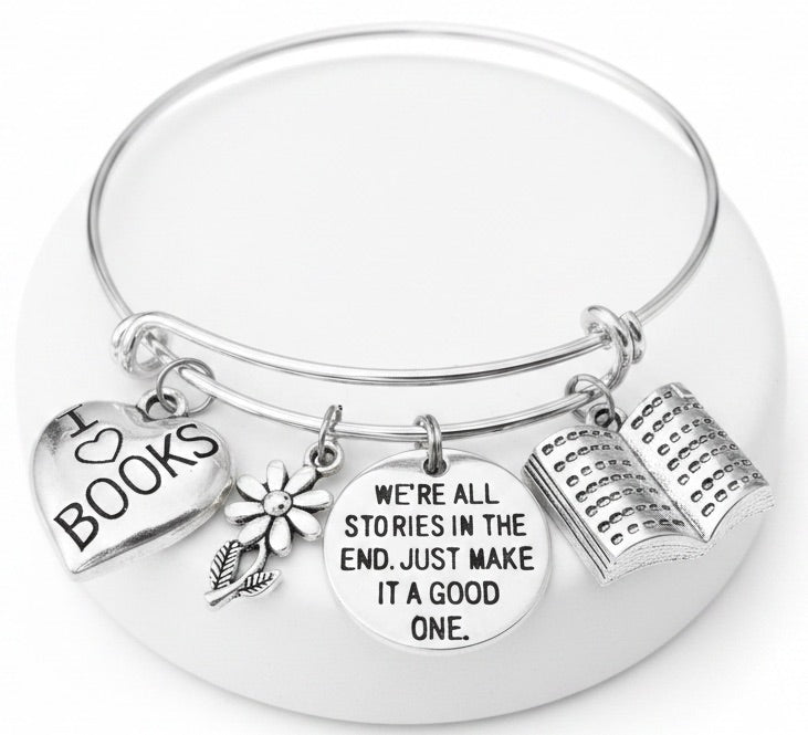 Silver expandable bangle bracelet with I Love Books heart charm, daisy flower charm, We're All Stories in the End disc charm, and open book charm — perfect gift for book lovers and readers