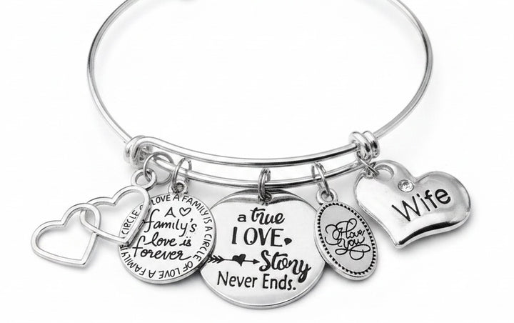 Silver expandable charm bracelet for wife featuring five charms: double interlocking hearts, A Family&
