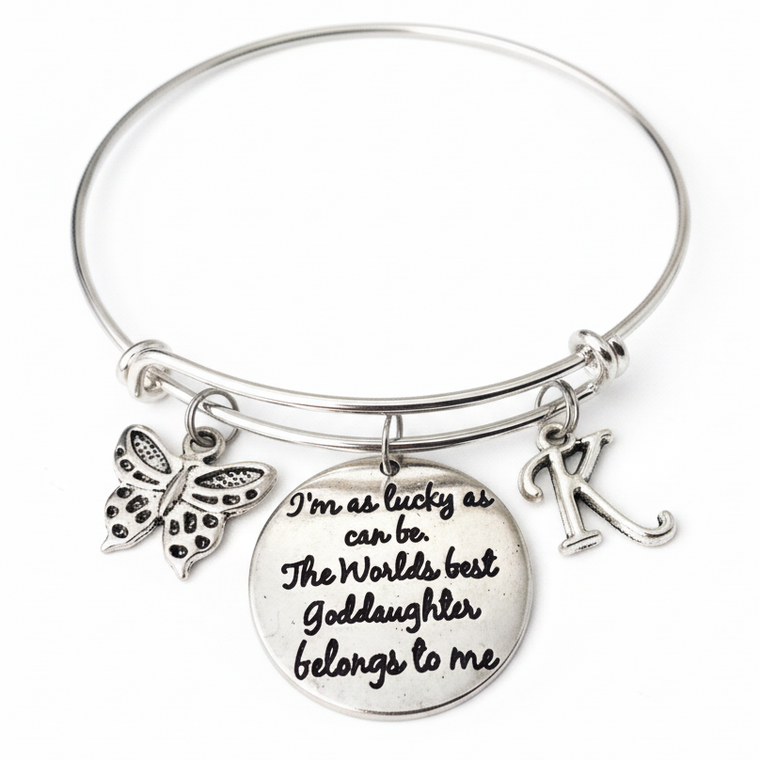 Silver expandable bangle bracelet with "World's Best Goddaughter" engraved quote disc, butterfly charm, and personalized initial charm – Goddaughter Baptism gift jewelry by Jules Obsession