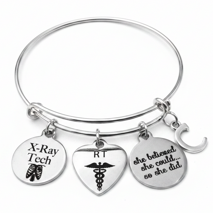 Personalized X-Ray Tech RT She Believed She Could charm bracelet with X-Ray Tech ribcage disc, RT heart caduceus disc, She Believed She Could engraved disc, and custom initial C charm — silver expandable bangle radiology graduation gift by Jules Obsession