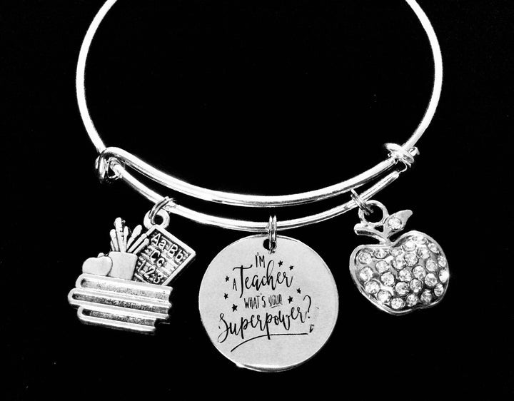 Silver expandable bangle bracelet with sparkling rhinestone apple charm, teaching supplies charm, and engraved "I&