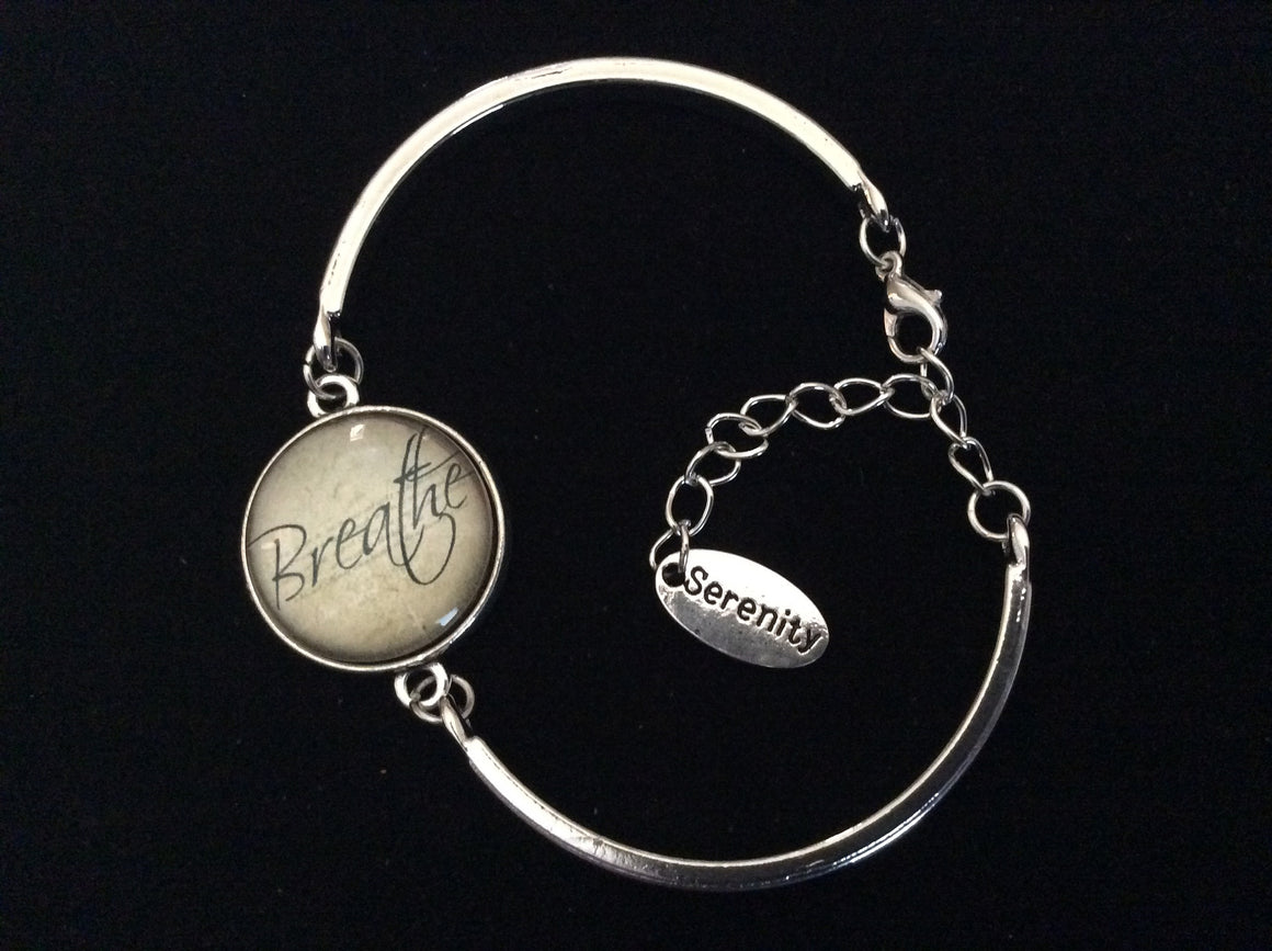 Breathe in Serenity Glass Domed Charm and Silver Stamped Serenity Tag Charm on a Silver Adjustable Cuff Bracelet
