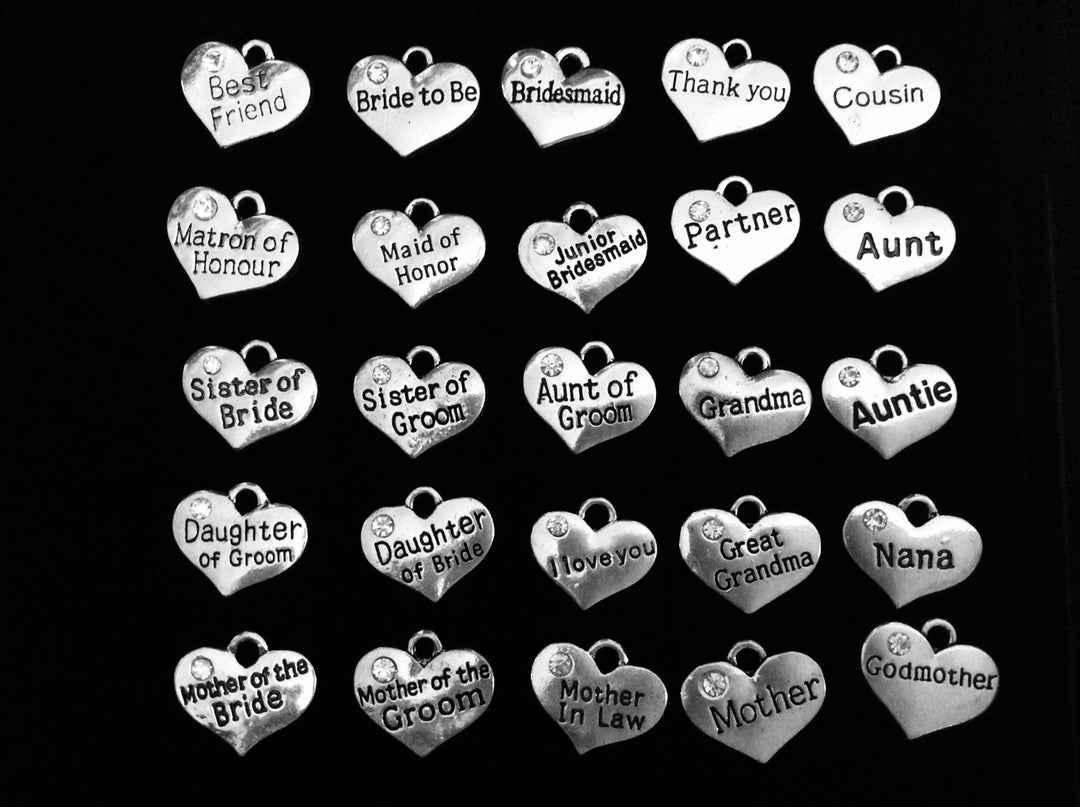 Silver-plated heart charm collection for Jules Obsession expandable bangle bracelets featuring engraved wedding party roles with crystal rhinestone accents including Best Friend, Bride to Be, Bridesmaid, Thank You, Cousin, Matron of Honour, Maid of Honor, Junior Bridesmaid, Partner, Aunt, Sister of Bride, Sister of Groom, Aunt of Groom, Grandma, Auntie, Daughter of Groom, Daughter of Bride, I Love You, Great Grandma, Nana, Mother of the Bride, Mother of the Groom, Mother In Law, Mother, and Godmother in ant