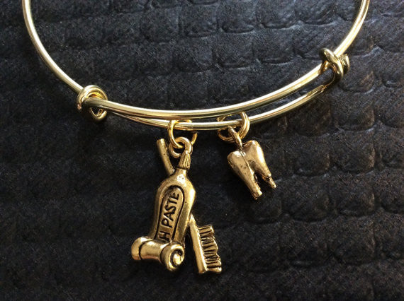 Gold Tooth and Toothbrush and Toothpaste Charm on an Expandable Adjustable Bangle
